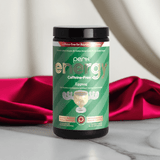 Energy Original CAFFEINE-FREE Eggnog (20 servings) in a green jar on a marble surface with red satin, highlighting its elegant packaging and caffeine-free formula.