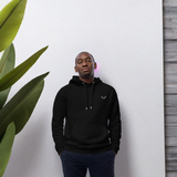 Velite Armor Premium Eco Hoodie in black worn by model, showcasing sustainable activewear with minimalist logo and modern fit.