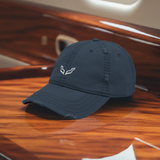 Velite Armor Premium Distressed Hat in navy blue, featuring an embroidered logo, placed elegantly on a polished wooden surface, exuding a luxury and elite style.