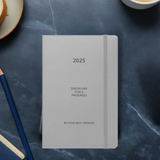 Velite Armor Premium Notebook in light gray with motivational quote, perfect for organizing goals and schedules in 2025.
