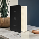 Standing black Velite Armor Premium Notebook with lined pages, perfect for journaling and structured planning in 2025.