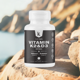 TeamKeto Vitamin K2 & D3 supplement bottle placed on a rocky outdoor background. Designed for active and healthy lifestyles.