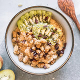 Healthy breakfast bowl topped with organic Navitas Organics Mulberries, fresh kiwi slices, and chia seeds, perfect for mindful eating.