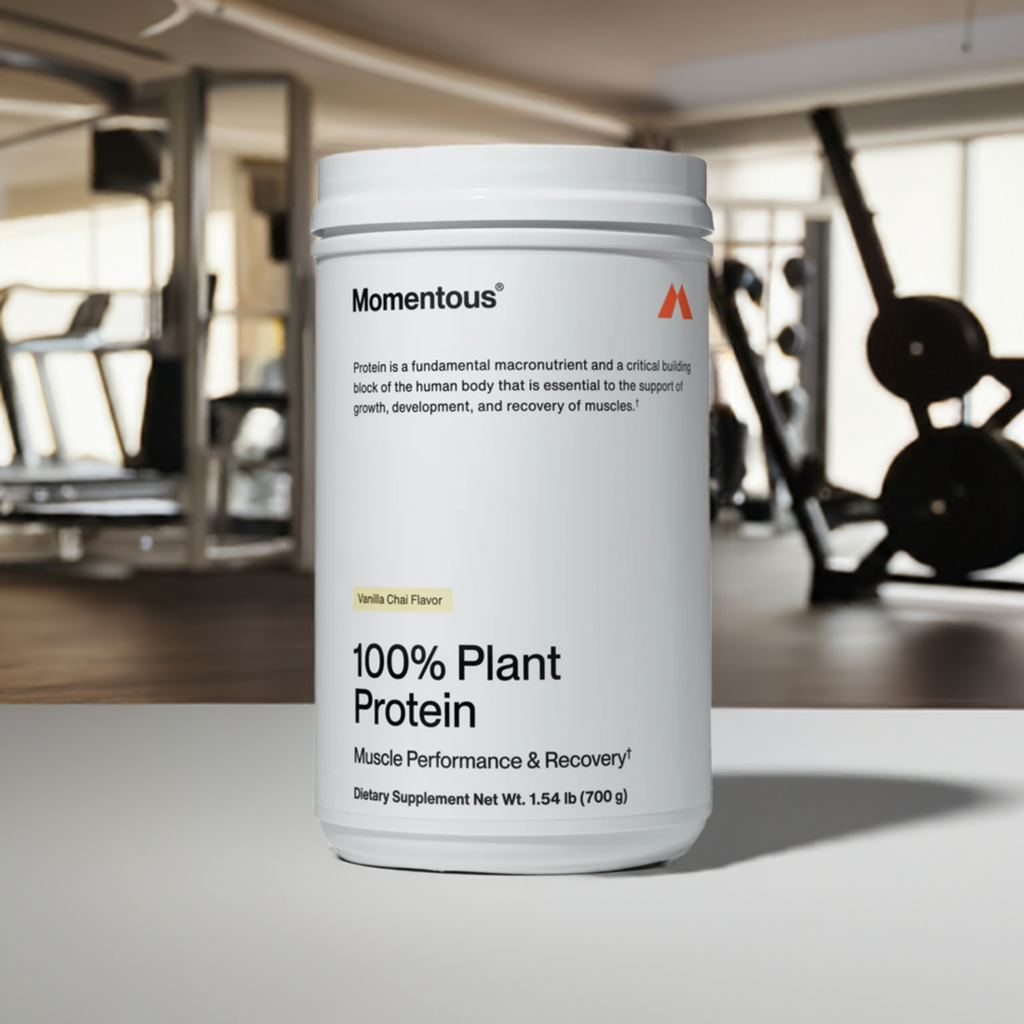 Momentous 100% Plant Protein Vanilla Chai in gym setting, ideal for muscle recovery and vegan fitness nutrition support.
