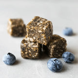 Blueberry Hemp Power Snacks displayed with whole blueberries and hemp seeds – nutritious superfood bites by Navitas Organics

