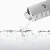 Boxed Water 500 ml – Pure & Sustainable Carton Packaging pouring purified water into clear liquid, showcasing freshness and eco-conscious design.