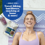 Social image of smiling woman holding Navitas Organics Power Snacks Blueberry Hemp pouch – gluten-free, non-GMO superfood

