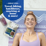 Social image of smiling woman holding Navitas Organics Power Snacks Blueberry Hemp pouch – gluten-free, non-GMO superfood

