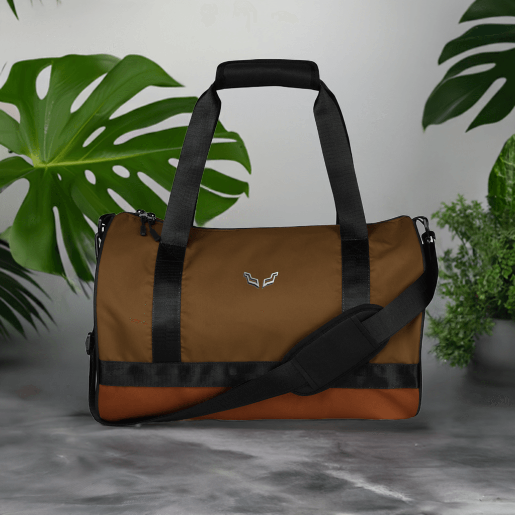Velite Armor Gym Bag displayed in a stylish setting with green plants, emphasizing its modern, water-resistant design.