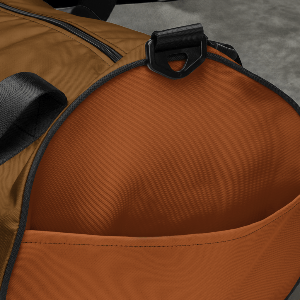 Close-up of Velite Armor Gym Bag's side pocket, showcasing durable polyester fabric and spacious interior for organized storage.