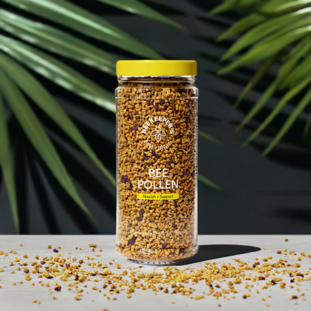 Beekeeper’s Naturals Bee Pollen jar on a surface with green leaves in the background.