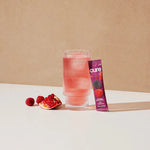 Glass of Cure Berry Pomegranate electrolyte drink with ice and pomegranate berries

