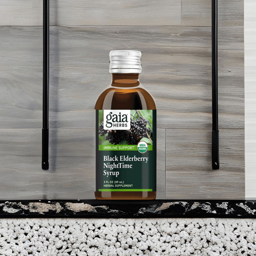 Black Elderberry Syrup - Organic Sleep Support | Immune Health bottle placed on modern surface, highlighting herbal supplement for restful sleep and immunity.