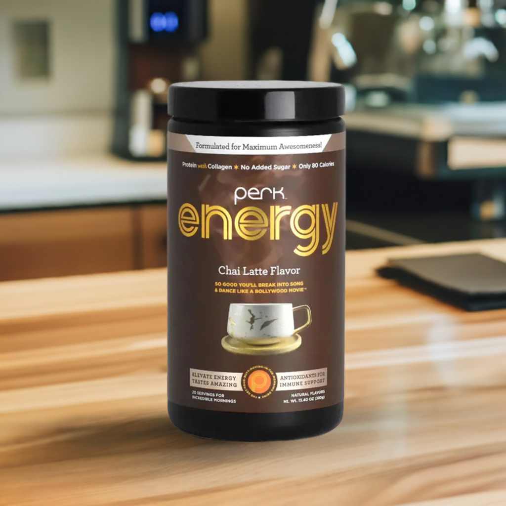 Perk Energy Chai Latte Flavor supplement on a wooden counter, featuring 20 servings of low-calorie, antioxidant-rich energy drink with natural spices.