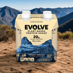Evolve Classic Chocolate Protein Shake 4-pack outdoors with mountain background, plant-based protein on-the-go