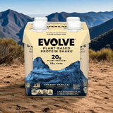 Evolve Classic Chocolate Protein Shake 4-pack outdoors with mountain background, plant-based protein on-the-go