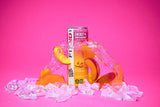FitAid Energy Peach Mandarin can surrounded by fresh peaches and mandarins on a vibrant pink background.

