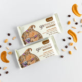 Flatlay of GoMacro bars with peanuts, chocolate chips, and apricot slices – clean, plant-based snack variety.