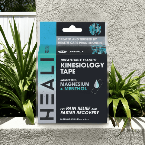 HEALI Kinesiology Tape box displayed outdoors with tropical plants, muscle and joint support tape for athletes

