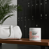 Healthy Energy Drink Powder – Boost Shot for Focus & Fat Burn in cotton candy flavor placed on a gym bench beside a white gym bag, ideal for fitness routines.