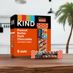 KIND Peanut Butter Dark Chocolate Bars 6-pack box on a tropical background, gluten-free with 7g protein per bar, ideal for healthy snacking.