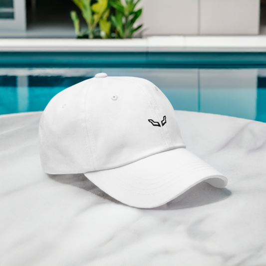 Low Profile Hat by Velite Armor in white chino cotton with embroidered logo, displayed poolside for a stylish and comfortable summer look.
