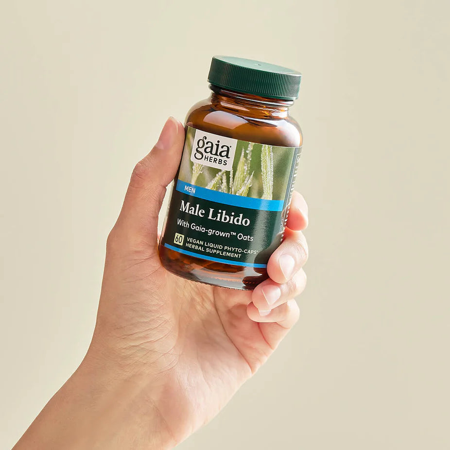 Hand holding Gaia Herbs Male Libido 60 ct bottle, highlighting vegan herbal supplement for stamina and male performance support.