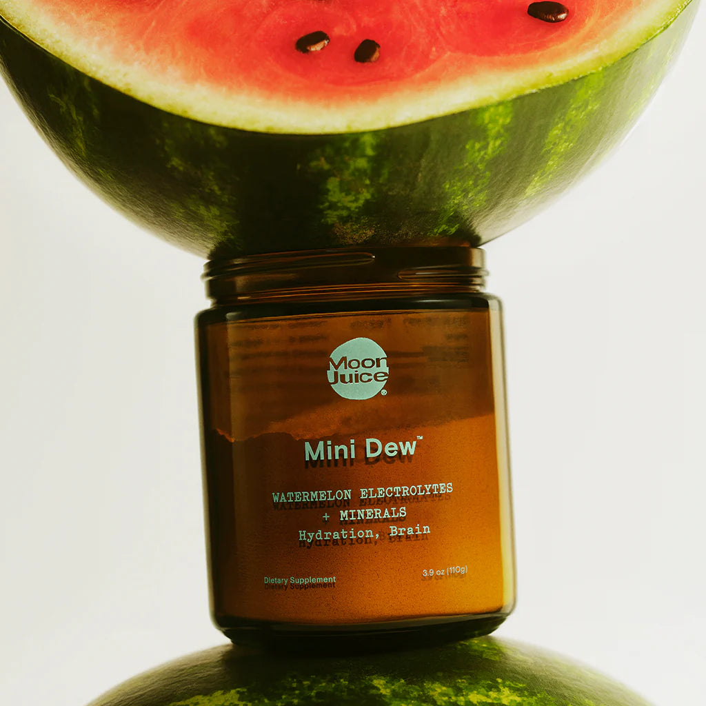 Mini Dew hydration and mineralization supplement in amber jar with watermelon, promoting brain function and electrolyte balance.