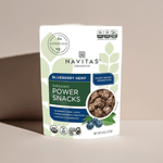 Close-up of Navitas Organics Blueberry Hemp Power Snacks pouch on beige table with soft lighting – organic vegan energy snack

