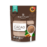 Front view of Navitas Organic Cacao Powder pouch with a spoonful of cacao and cinnamon sticks on the packaging.