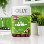 Olly Daily Energy Gummies – Tropical Passion with B12, CoQ10 & Goji Berry, 60 ct bottle placed in a modern kitchen. Natural energy boost supplement.