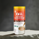 OM Mushroom Chai Blend – Focus, Balance & Immune Support Drink in a 30-serving container, displayed on a stone surface for wellness appeal.