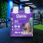 OWYN Plant-Based Protein Shake 20g – Cookies & Creamless flavor multipack on gym bench with fitness gear.