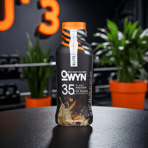OWYN Pro Elite Chocolate Peanut Butter Protein Shake – 35g plant-based protein, keto-friendly, zero sugar, displayed in gym setting for fitness lifestyle.