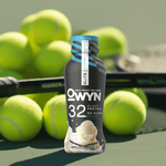 OWYN 32g Vanilla Protein Shake bottle placed in front of fresh green apples, highlighting clean and healthy nutrition.