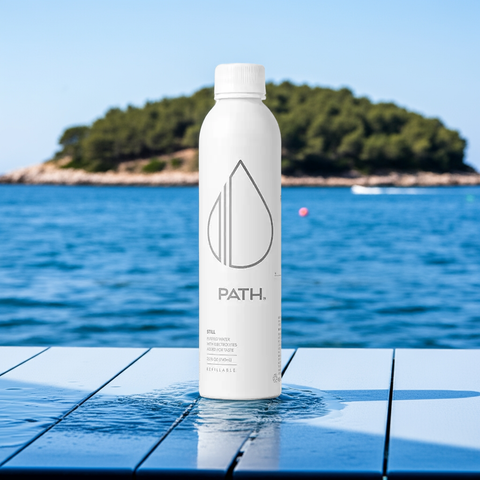 Reverse-osmosis aluminum water bottle on wet surface by the sea - eco-friendly, refillable and BPA-free hydration solution

