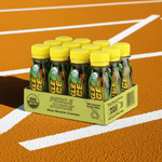 "12-pack of Extra Strength Pickle Juice Shots with yellow caps on a wooden surface, concentrated electrolyte drink for cramp relief."