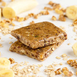 Close-up of Probar Banana Nut Bread bar with banana chips and oats, nutrient-rich plant-based snack