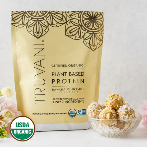Truvani Organic Plant-Based Protein powder in vanilla flavor pouch with a scoop on a clean kitchen counter.