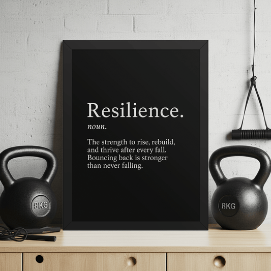 Resilience Framed Poster 12x16 – Motivational Wall Art for Success displayed in a home gym with kettlebells, featuring bold black-and-white typography. Ideal for inspiring strength and perseverance in workout or office spaces.