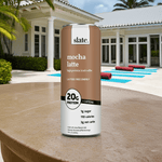 Slate Milk Classic Chocolate protein shake next to pool, highlighting a healthy, summer-friendly chocolate drink.