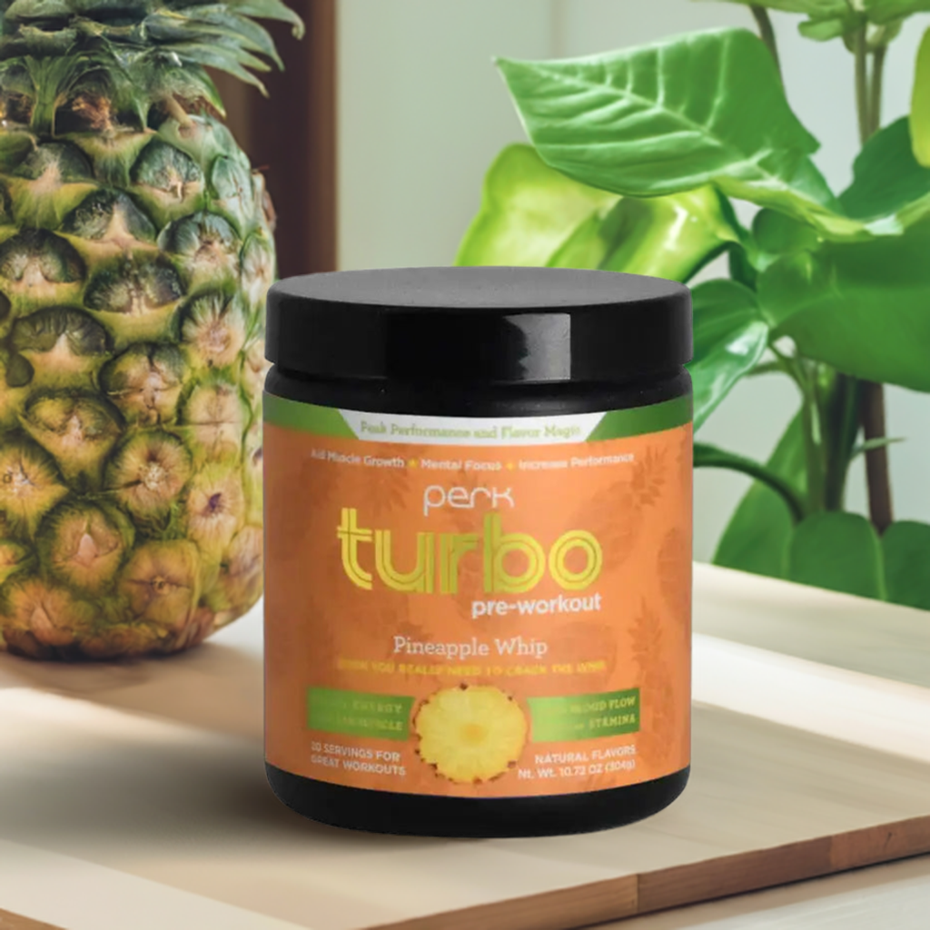 Turbo Pineapple Pre-Workout Supplement by Perk Energy with 20 servings, shown on a wooden table with fresh pineapple and tropical leaves.