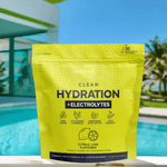 Citrus Lime Hydration + Electrolytes pouch beside a bright blue pool and modern architecture, promoting active hydration in warm weather.