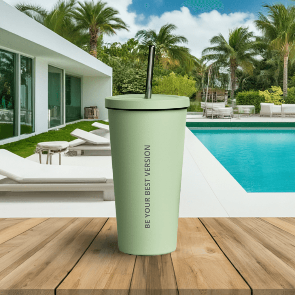 Pastel green Velite Armor Insulated Tumbler on wooden deck near pool, perfect for stylish summer hydration outdoors.