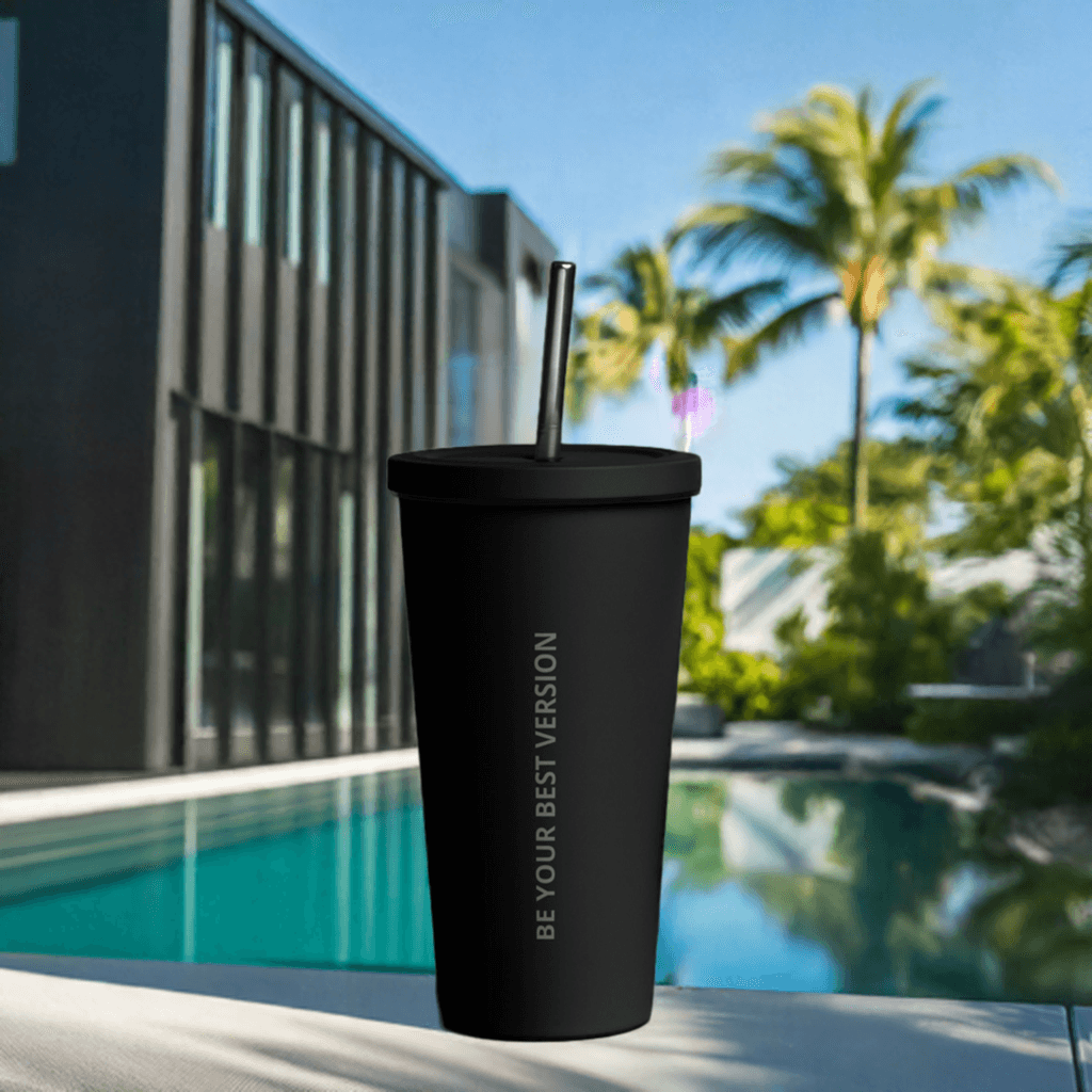 Black Velite Armor Insulated Tumbler by a luxury poolside, combining elite style and functionality for outdoor hydration.