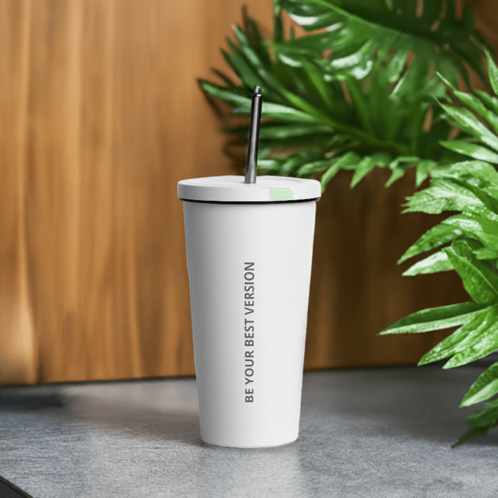 White Velite Armor Insulated Tumbler on countertop with greenery, merging modern design with natural lifestyle aesthetics.