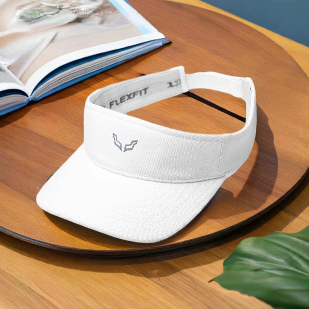 Velite Armor Performance Visor in white with low-profile design and Flexfit band, ideal for workouts and casual wear. Sleek unisex accessory on wooden table.