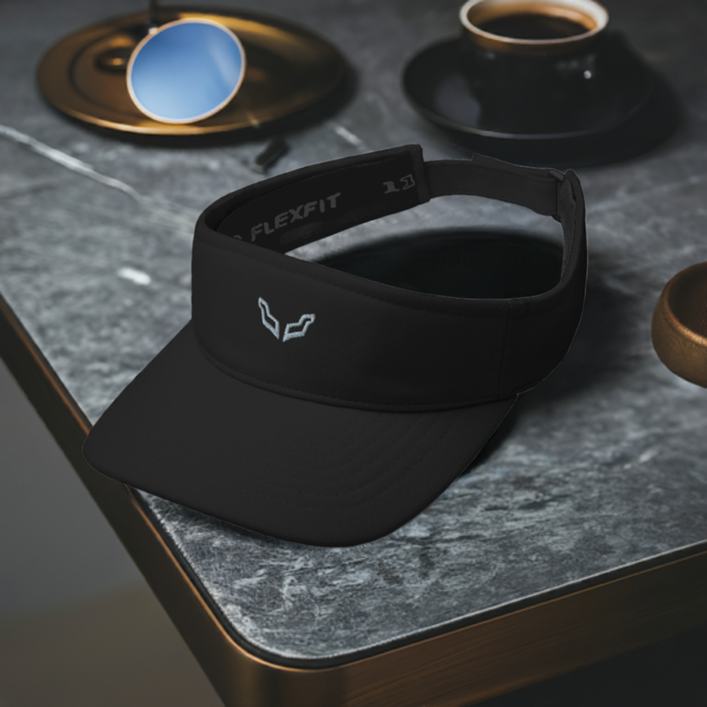 Velite Armor Performance Visor in black with low-profile design and reflective logo, placed on a modern marble table beside coffee cups and sunglasses.