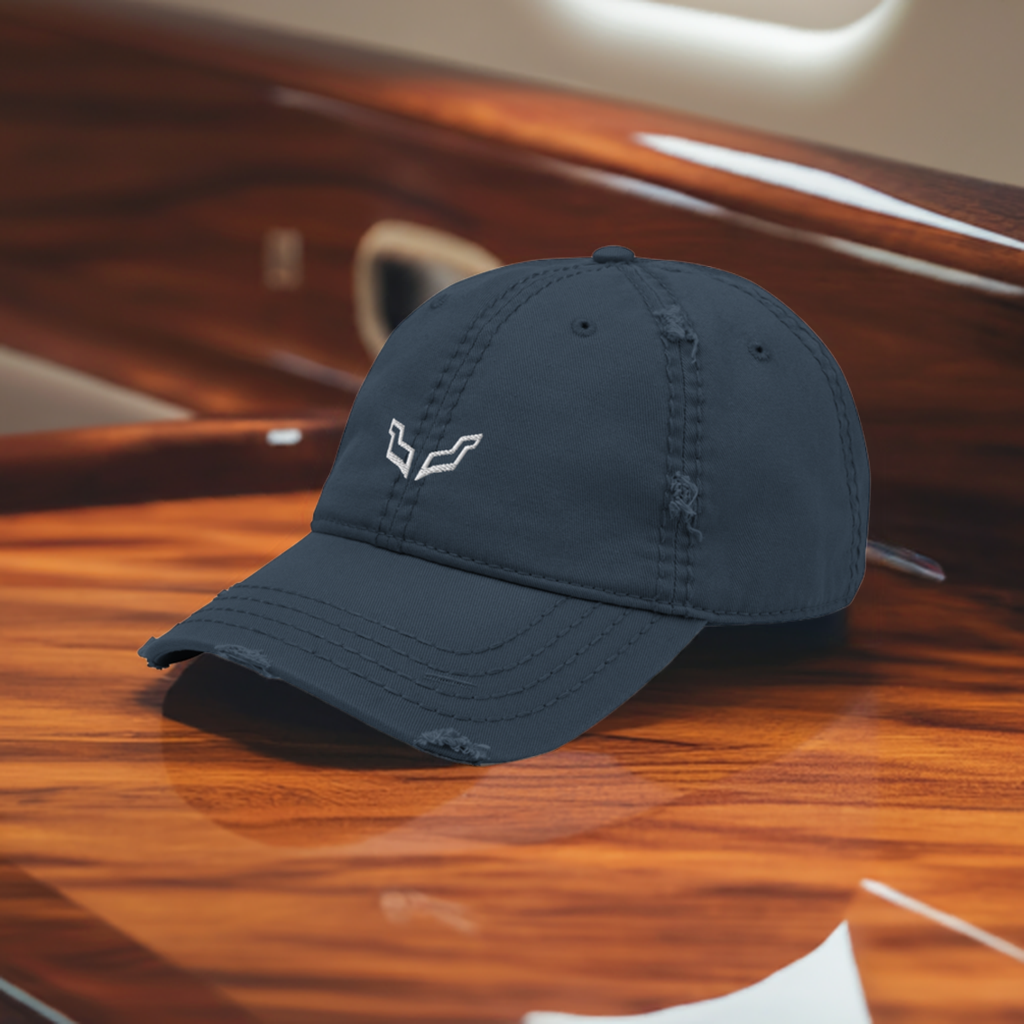 Velite Armor Premium Distressed Hat in navy blue, featuring an embroidered logo, placed elegantly on a polished wooden surface, exuding a luxury and elite style.