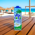 Vita Coco Coconut Water front label close-up on tropical patio, ultimate hydration from coconuts.
